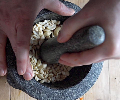 Gently grinding cashews into meal