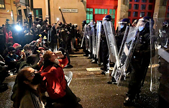 Peaceful protesters face down violent police suppression in Bristol, 2020.