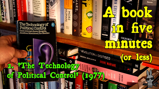 A hand takes a copy of ‘The Technology of Political Control’ from a shelf