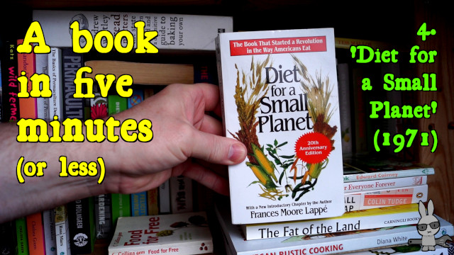 A hand holding a copy of ‘Diet for a Small Planet’