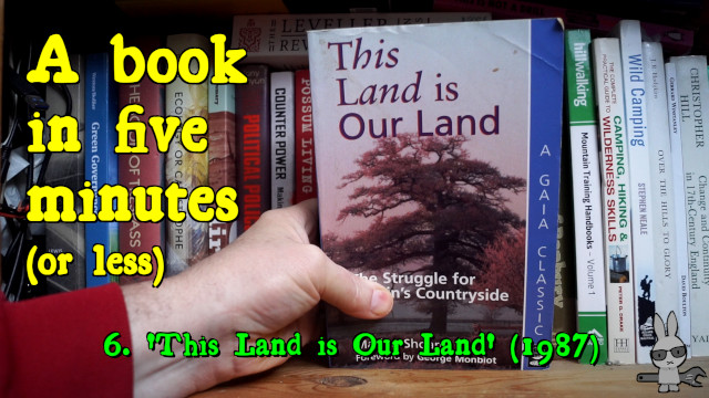 A hand holding a copy of ‘This Land is Our Land’