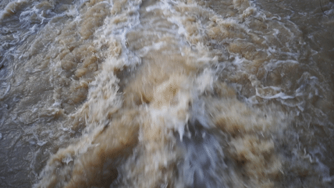 animation of a muddy flooded river torrent