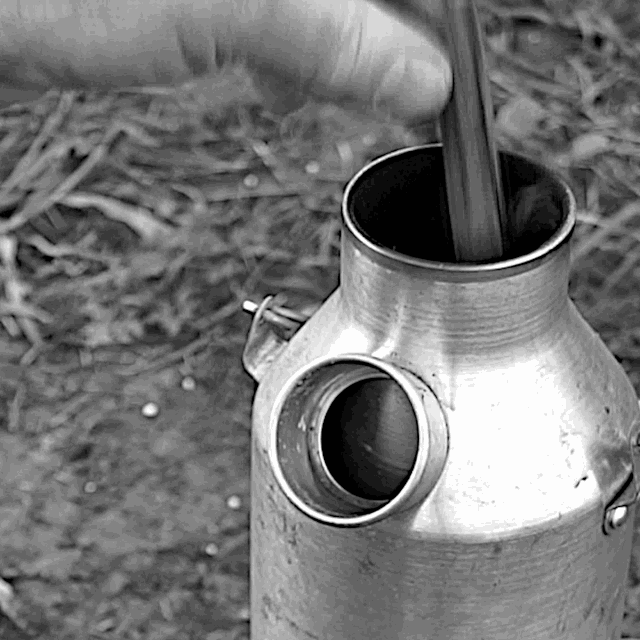 Using the Kelly Kettle: As flames from chimney begin to die down, drop a few more broken twigs down chimney
