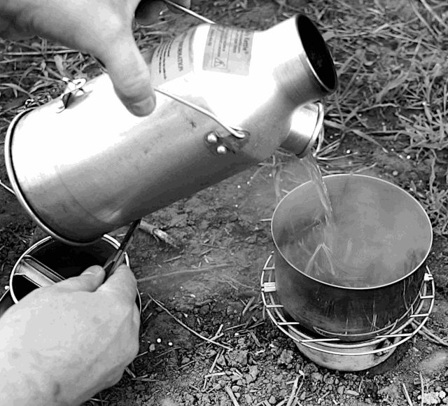 Kettle boiling over an open flame while camping, Atlin, British